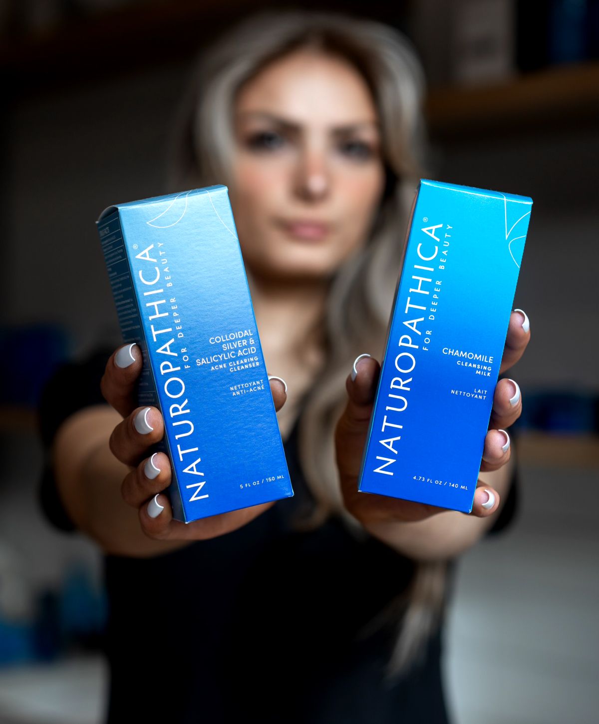 Beauty products displayed by a person.
